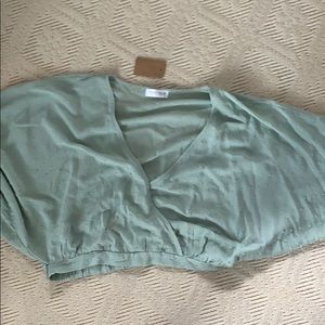 A pastel green v neck shirt